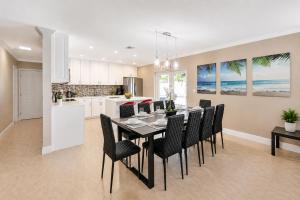 a kitchen and dining room with a table and chairs at Walk to Hollywood Beach Luxury 4BR Villa in Hollywood +31 photos