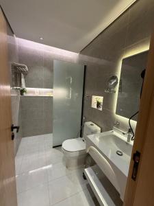 a bathroom with a toilet and a sink at Bright Moon in Al-ʿUla