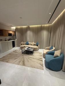 a living room with two couches and a table at Bright Moon in Al-ʿUla