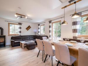 a living room with a table and chairs and a couch at Ebersberger in Donnersbachwald +25 photos