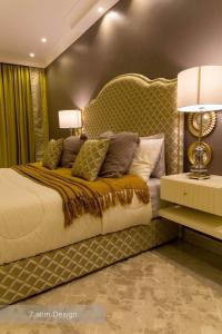 a bedroom with a large bed with a large headboard at Chalet A4 Mirbat in Mirbāţ