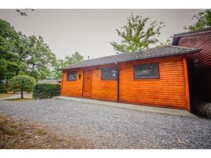a house with an orange wall at Le Beau Renard in Heure +4 photos