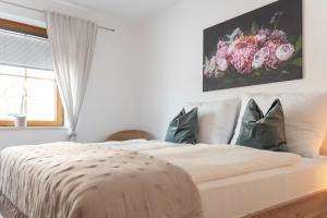 a bedroom with a white bed with pillows and a window at Pirkners Home in Sooss