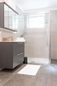 a bathroom with a shower and a sink at Pirkners Home in Sooss +30 photos