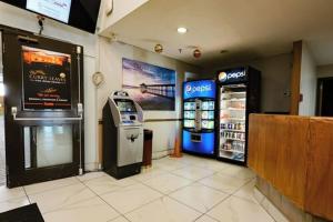 a store with a soda machine and a cash register at Confederation Inn Saskatoon in Saskatoon