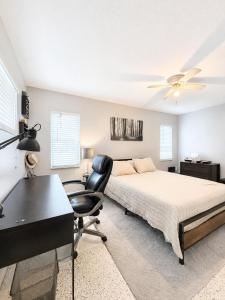 a bedroom with a bed and a desk and a chair at Bradenton Oasis Private Backyard and Firepit in Bradenton