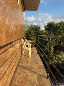 a patio with a table and a chair on a balcony at JAARR Alojamientos in Pucallpa