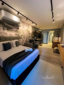 a bedroom with a large bed and a living room at Skylux By Cris Borriello Luxury in Rio de Janeiro