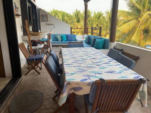 a room with a table and chairs and a couch at Villa 24C Los Cabos Monterrico in Monterrico