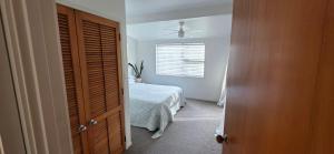 a bedroom with a bed and a ceiling fan at Point Wells Village Bach in Omaha