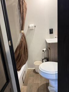 a bathroom with a toilet and a shower curtain at Rv The Ark Camper in Hollywood +33 photos
