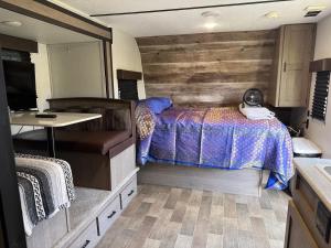 a bedroom with a bed and a table in it at Rv The Ark Camper in Hollywood