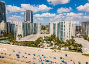 a beach with a bunch of umbrellas and buildings at Rv The Ark Camper in Hollywood