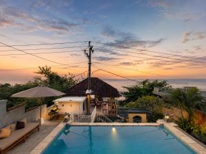 a swimming pool with a view of the ocean at SūKha Amed in Culik