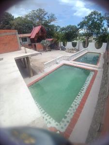 a swimming pool in the middle of a house at Hotel La Parrilla Boyacense Rivera in Rivera