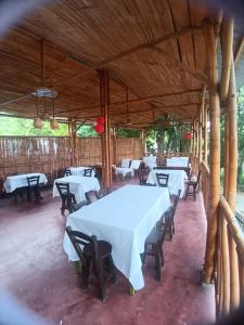 a dining area with tables and chairs in a pavilion at Hotel La Parrilla Boyacense Rivera in Rivera