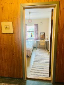 a hallway leading to a bedroom with a bed at Rosahuset in Kabelvåg