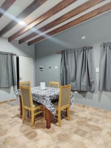 a dining room with a table and chairs at Alojamiento Quilla-Unta in Fiambalá