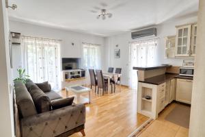 a living room with a couch and a dining room at Fiumera Kotor Apartment in Kotor