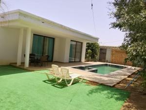 a house with two chairs and a swimming pool at Amazone in Ngaparou