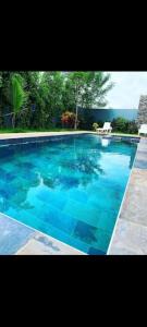 a large swimming pool with blue water at Amazone in Ngaparou +5 photos