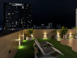 a balcony with a chair on the roof at night at Sirari Palm 102 in Santa Cruz de la Sierra