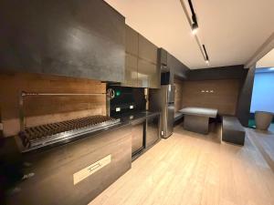 a kitchen with wooden floors and stainless steel appliances at Sirari Palm 102 in Santa Cruz de la Sierra