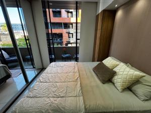 a large bed in a room with a large window at Sirari Palm 102 in Santa Cruz de la Sierra +24 photos