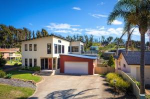 a large white house with a large garage at Fanta Sea in Tathra