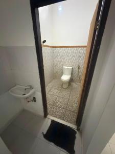 a small bathroom with a toilet and a sink at Amed beach homestay in Ambat