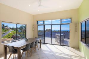 a dining room with a table and chairs at Fanta Sea in Tathra