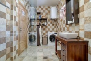 a bathroom with a sink and a washing machine at Fiumera Kotor Apartment in Kotor +50 photos