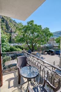 a patio with a table and chairs on a balcony at Fiumera Kotor Apartment in Kotor