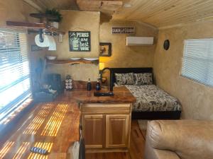 a kitchen with a sink and a bed in a room at The Last Resort in Ruidoso