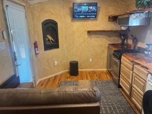 a living room with a couch and a kitchen at The Last Resort in Ruidoso +2 photos