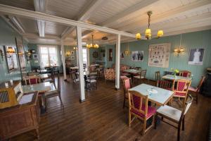 a restaurant with tables and chairs in a room at Einarshúsid Guesthouse in Bolungarvík