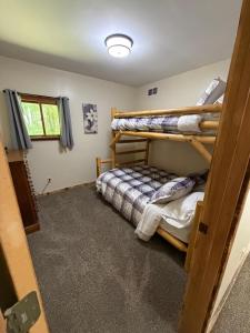 a bedroom with bunk beds in a house at Maple Ridge Trail Side Cabin in Crandon