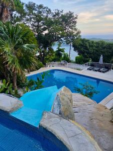 a swimming pool with a rock around it at Rincon Frente al mar in Acapulco