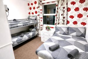 a bedroom with two bunk beds and a window at Blackpool Central Lodge in Blackpool