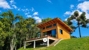 a wooden house on top of a hill at Cabana Bad Wolf - Rancho Queimado - SC in Rancho Queimado