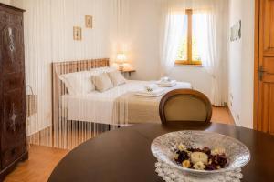 a bedroom with a bed and a table with a bowl on it at Villa Olimpo B&B in Fasano