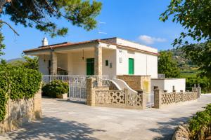 a house with a gate and a fence at Villa Olimpo B&B in Fasano +21 photos