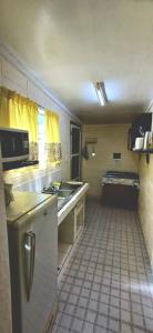 a small kitchen with a sink and a stove at Talanoa Fales Accommodation in Apia +12 photos