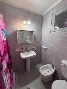 a bathroom with a sink and a toilet and a mirror at Alojamiento LowCost San Rafael in San Rafael +7 photos