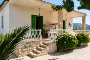 a house with a staircase and a green door at Villa Olimpo B&B in Fasano