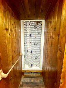 a window in a room with a curtain with stars at Caribou Cabin -Rustic Cabin with Sauna in Delta Junction