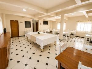 a large room with a table and chairs in it at hotel Maanaim in Candói