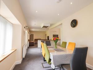a dining room with a table and chairs at Millmoss Cottage in Turriff