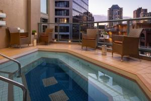 a swimming pool on top of a building at The Parker Hotel and Rooftop in Vancouver