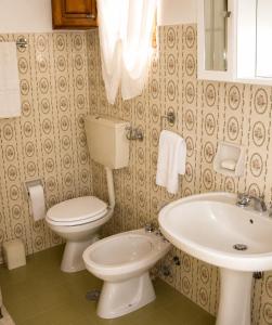 a bathroom with a toilet and a sink at Villa Olimpo B&B in Fasano